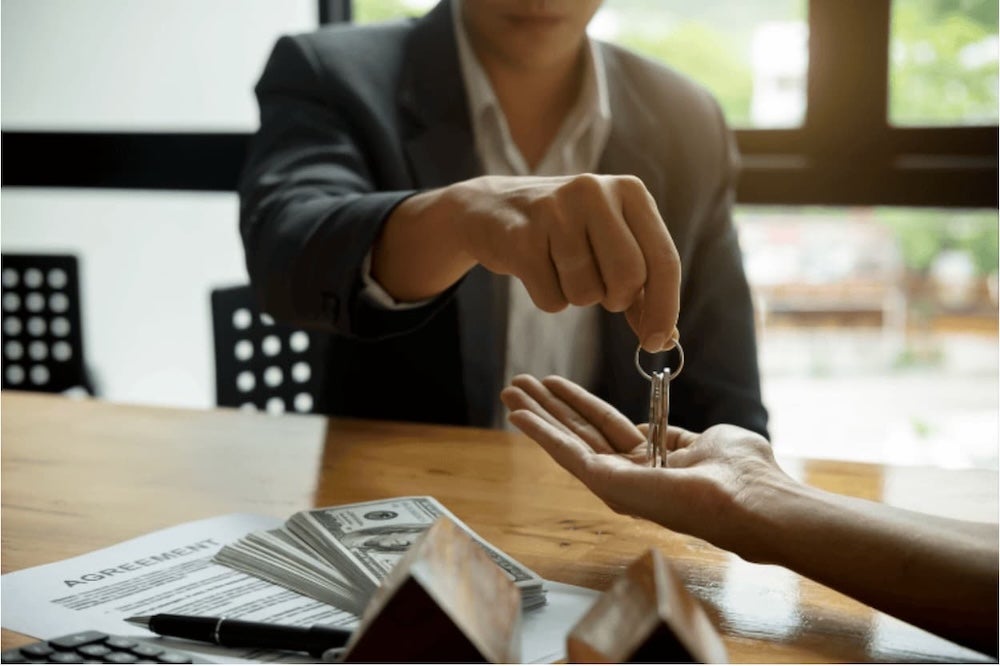 Someone handing over some house keys