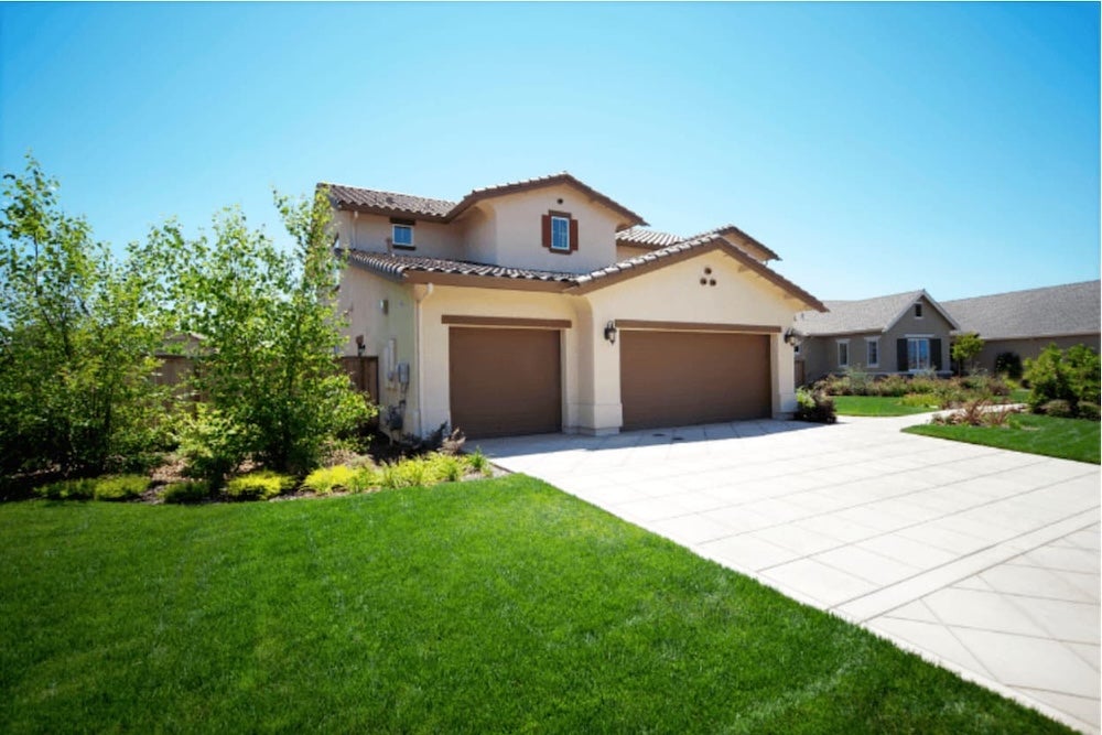 An image of a house infront of a blue sky