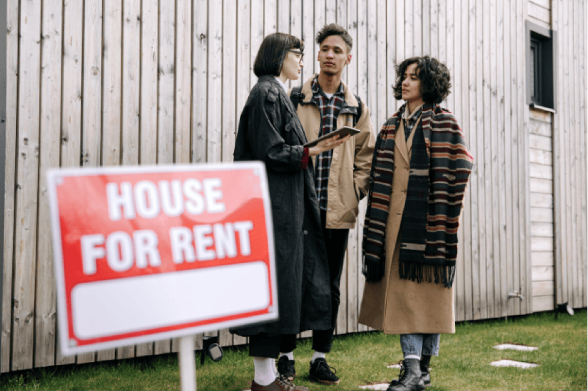 A couple being welcomed into a home by an agent