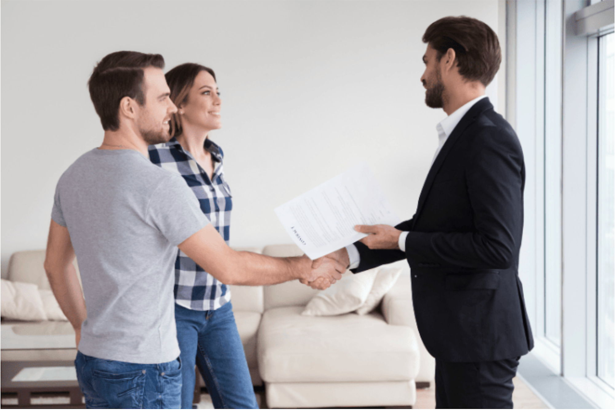 A couple shaking hands with an agent