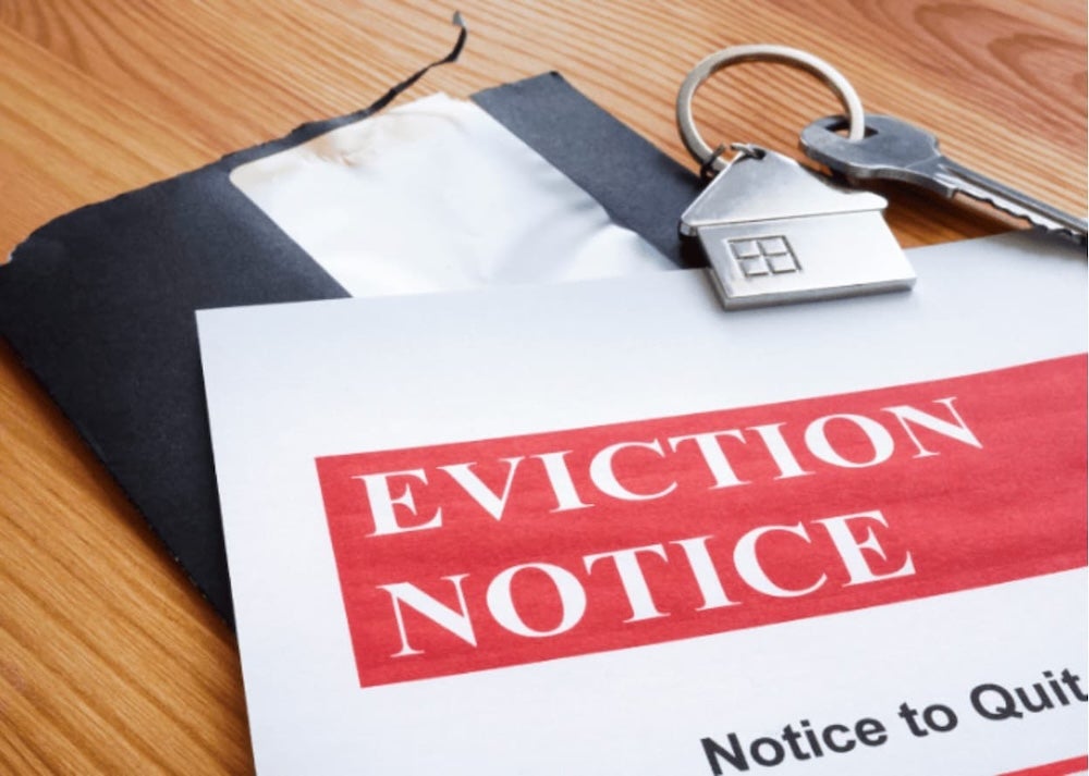 An eviction notice on a desk with keys
