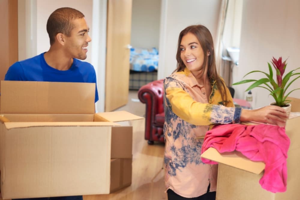Two roommates unpacking boxes