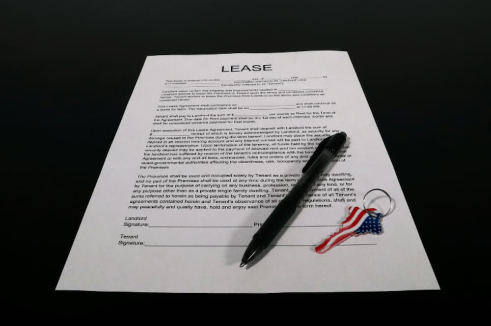 A lease document on a desk with a pen and keys