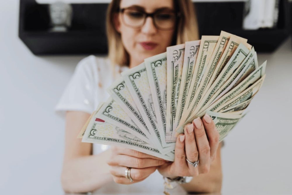 An image of someone fanning out money in their hand