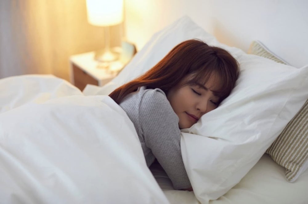 Somebody asleep in a bed