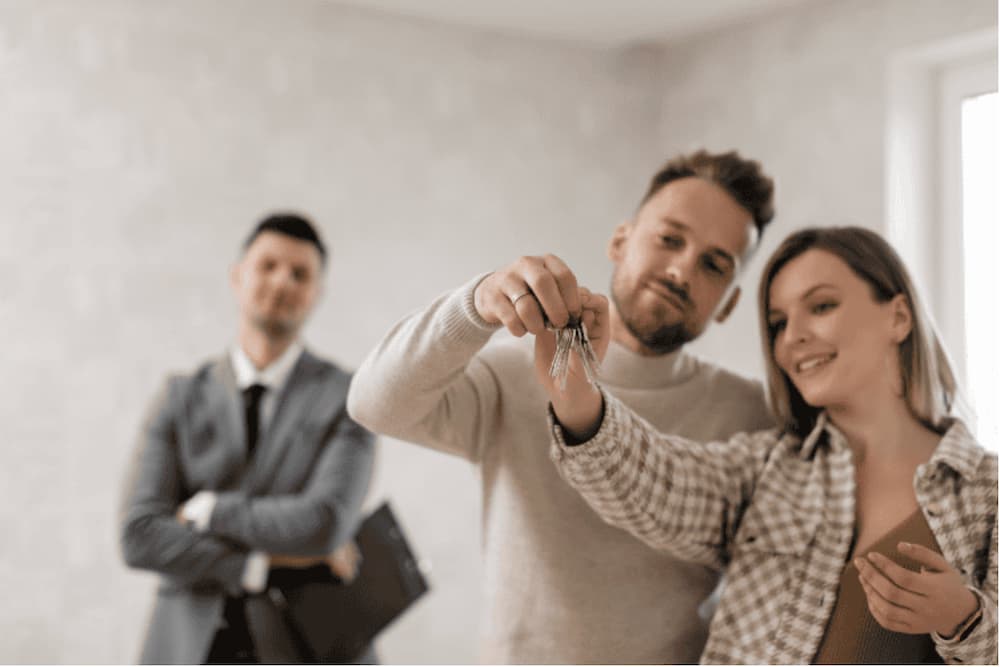 An image of a couple getting keys from an agent