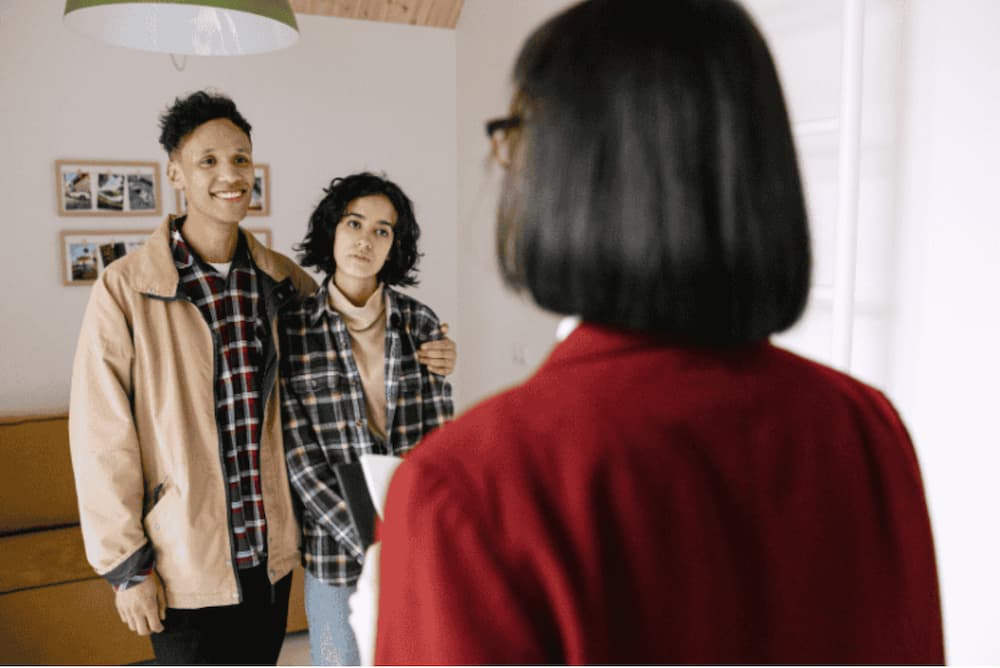 An image of a couple talking to an agent
