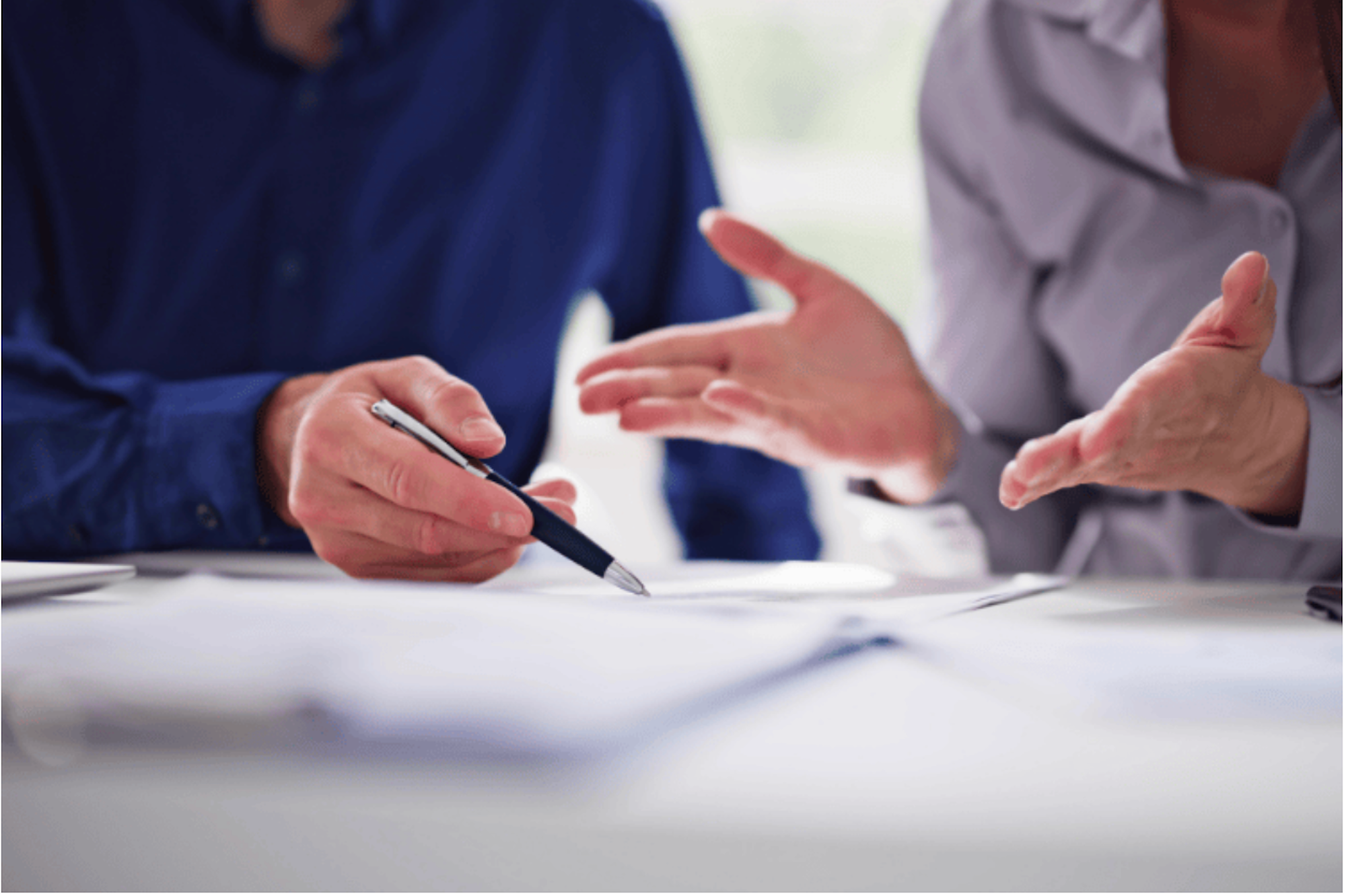 Two people discussing a document