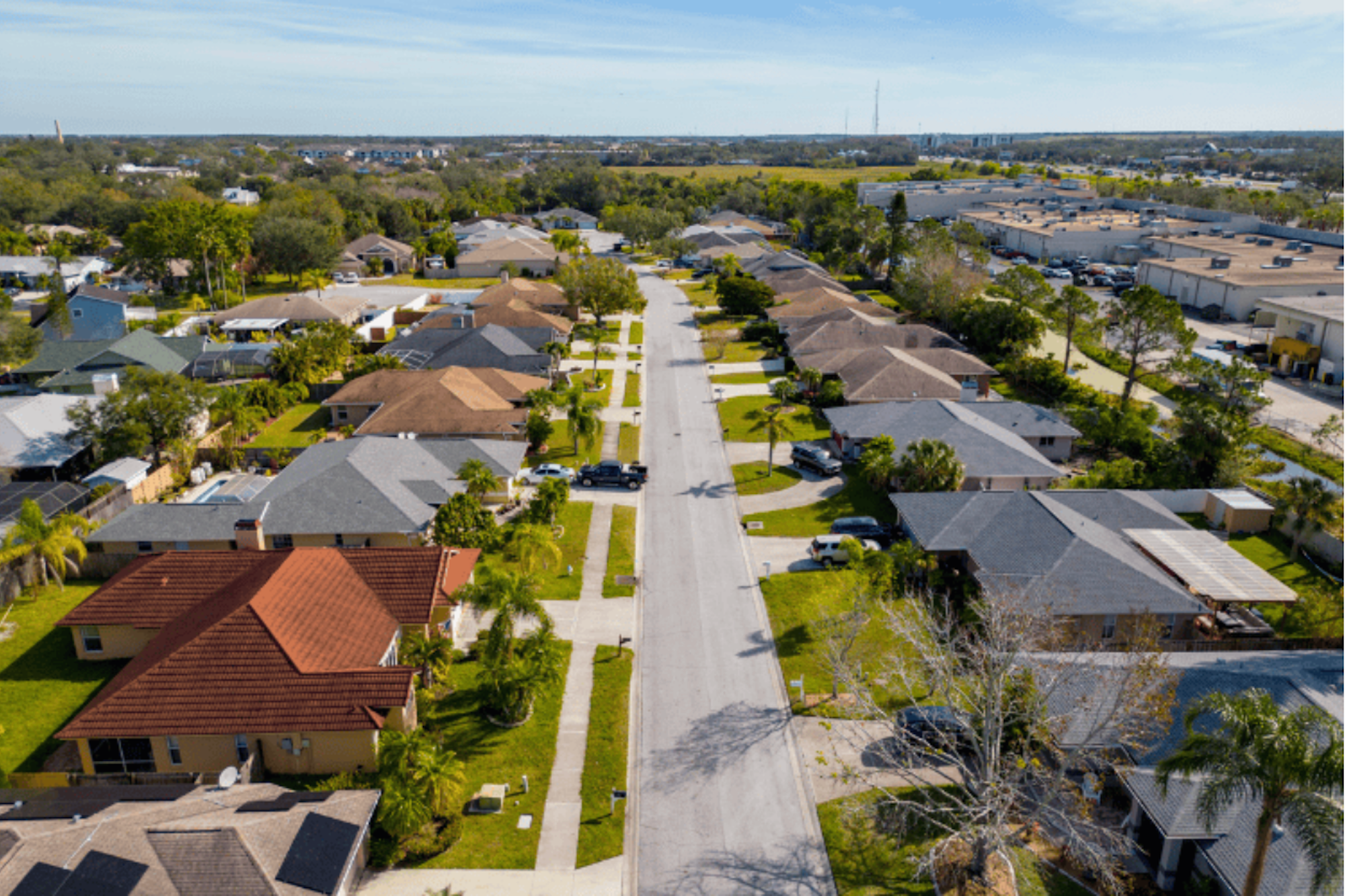 A birdseye view of suburban houses on a street