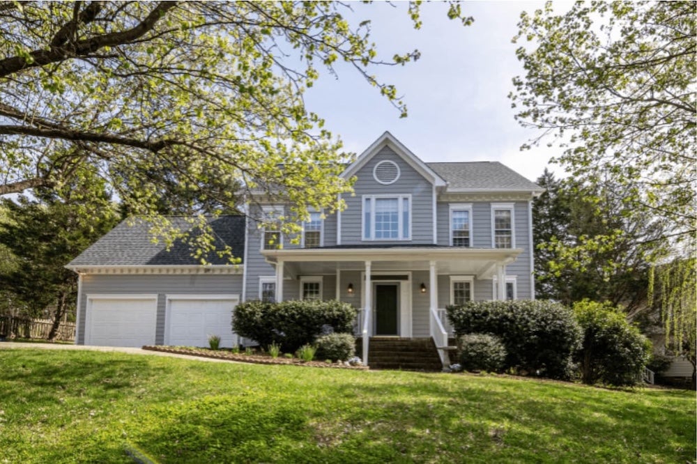 An image of a house with the garden in the foreground