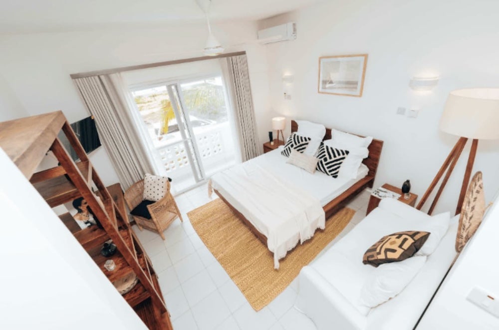 A view of a tidy living room leading to a bedroom