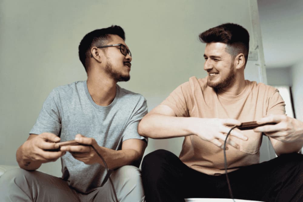 An image of two people sat on a couch on their phones