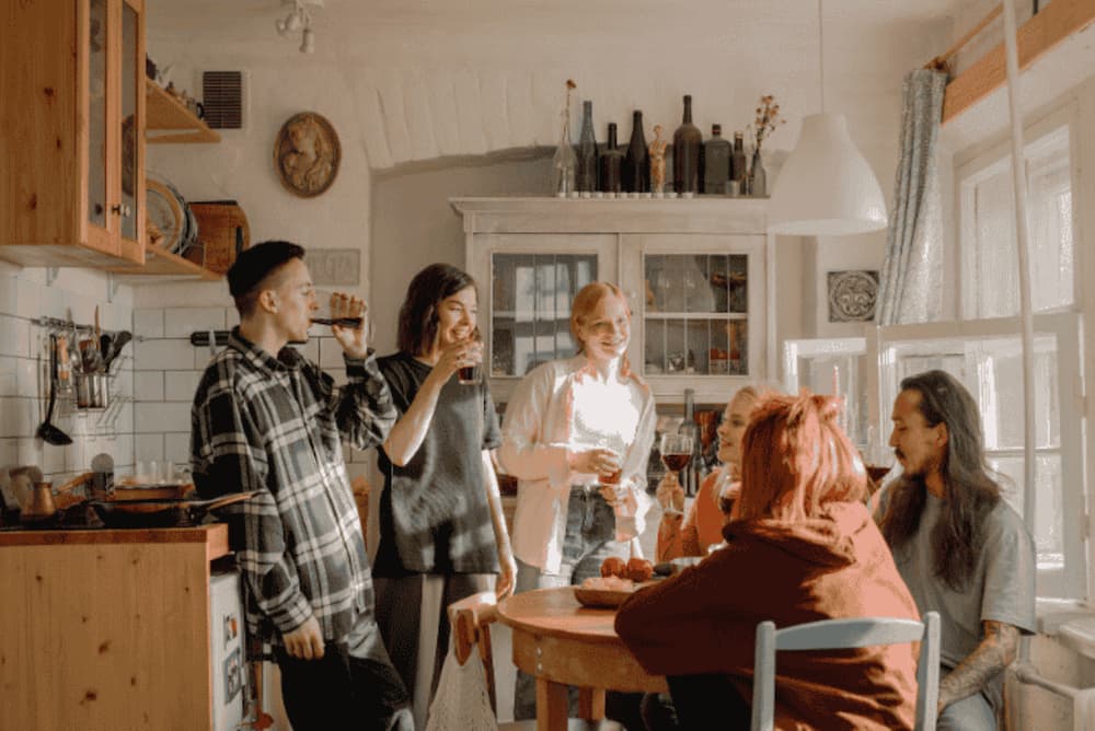 An image of a group of people sat around a table