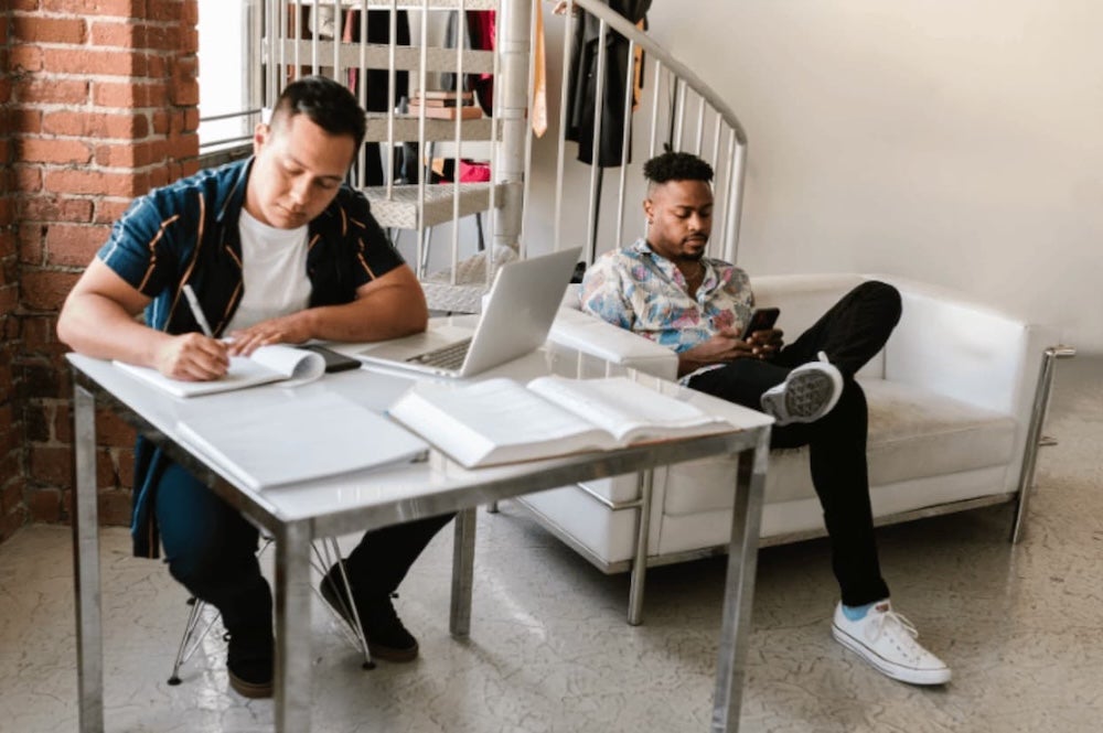 Four roommates sitting around a table for work