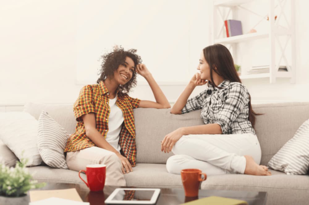 Two roommates sitting on a couch