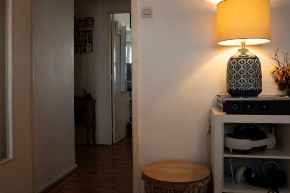 An image of a lamp on a stand in a living room