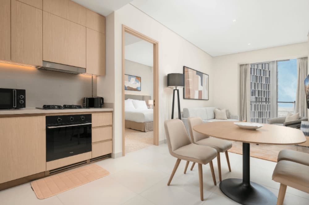 An image of a tidy appartment looking at the open living room and kitchen