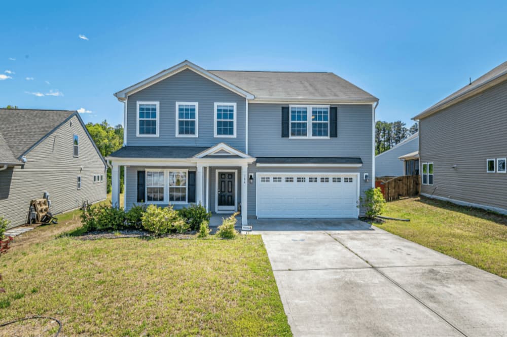 An image of a nice house and tidy yard out the front